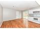 Bright kitchen featuring granite counters, white appliances, and hardwood floors at 10362 Delphi Ct, Fishers, IN 46038