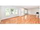 Spacious, well-lit living room with hardwood floors, large windows, and ample space at 10362 Delphi Ct, Fishers, IN 46038