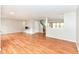 Open-concept living area with hardwood floors, neutral paint, and abundant natural light at 10362 Delphi Ct, Fishers, IN 46038