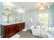 Elegant bathroom with a soaking tub, large vanity, and walk-in shower at 10752 Tallow Wood Ln, Indianapolis, IN 46236