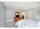 This bedroom features neutral walls, soft carpet, a TV on a dresser, and a floral patterned comforter at 10752 Tallow Wood Ln, Indianapolis, IN 46236
