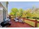 Outdoor deck area with comfortable patio furniture, flower pots, and a grill for entertaining at 10752 Tallow Wood Ln, Indianapolis, IN 46236