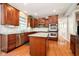 Well-equipped kitchen boasts an island, stainless appliances, and plentiful cherry wood cabinetry at 10752 Tallow Wood Ln, Indianapolis, IN 46236
