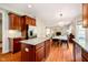 Open concept kitchen features stainless appliances, island, and a dining area with fireplace at 10752 Tallow Wood Ln, Indianapolis, IN 46236