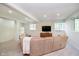 The living room features soft carpet, a large sectional sofa, recessed lighting, and a tv at 10752 Tallow Wood Ln, Indianapolis, IN 46236