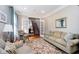 Inviting living room featuring a sofa, an armchair, and an area rug on hardwood floors at 10752 Tallow Wood Ln, Indianapolis, IN 46236