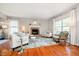 Inviting living room features a fireplace, hardwood flooring, and lots of natural light at 10752 Tallow Wood Ln, Indianapolis, IN 46236