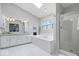 Clean and modern bathroom with large soaking tub, glass shower, and tiled floors at 11264 Fonthill Dr, Indianapolis, IN 46236
