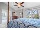 Primary bedroom with natural light, carpeted floors, and a four-poster bed at 11264 Fonthill Dr, Indianapolis, IN 46236