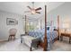 Primary bedroom with natural light, carpeted floors, and a four-poster bed at 11264 Fonthill Dr, Indianapolis, IN 46236