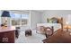 Bright bedroom featuring a large window, wooden bed frame, and patterned armchair at 11264 Fonthill Dr, Indianapolis, IN 46236