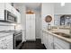 Bright kitchen features stainless steel appliances, granite countertops, and sleek white cabinets at 11264 Fonthill Dr, Indianapolis, IN 46236