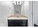 Elegant powder room with dark vanity, decorative mirror, and mosaic tile backsplash at 11264 Fonthill Dr, Indianapolis, IN 46236