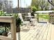 Outdoor back deck space featuring white patio furniture and decorative plant accents at 1136 Lawrence Ave, Indianapolis, IN 46227
