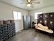 Bright bedroom featuring wood-look floors, built-in storage, and a decorative chaise lounge at 1136 Lawrence Ave, Indianapolis, IN 46227