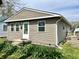 Charming home featuring vinyl siding, a well-manicured lawn, and blooming plants adding curb appeal at 1136 Lawrence Ave, Indianapolis, IN 46227