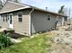 Exterior view showcases vinyl siding, a well-manicured lawn, and blooming plants adding curb appeal at 1136 Lawrence Ave, Indianapolis, IN 46227