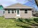 Charming home featuring vinyl siding, a well-manicured lawn, and blooming plants adding curb appeal at 1136 Lawrence Ave, Indianapolis, IN 46227