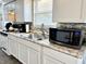 Well-lit kitchen features stainless steel appliances, granite countertops, and ample storage space at 1136 Lawrence Ave, Indianapolis, IN 46227