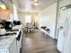 Modern kitchen with white cabinetry, stainless steel appliances, and a bright dining area at 1136 Lawrence Ave, Indianapolis, IN 46227