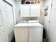 Functional laundry room equipped with a washer, dryer, and storage cabinets for convenience at 1136 Lawrence Ave, Indianapolis, IN 46227