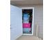 Doorway leading to a packed storage area with various bins and equipment at 1136 Lawrence Ave, Indianapolis, IN 46227