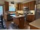 Charming kitchen features oak cabinets, stainless steel appliances, an island, and decorative tile backsplash at 11786 Ledgestone Cir, Fishers, IN 46037
