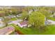 Overhead view of homes with expansive green lawns, tree-lined streets, and mature trees at 1213 Fairview Dr, Greenfield, IN 46140