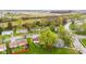 An aerial view shows homes with mature trees and green yards in a quiet residential neighborhood at 1213 Fairview Dr, Greenfield, IN 46140