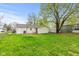 Expansive backyard featuring a well-maintained lawn, storage shed and a partially fenced in area for outdoor relaxation at 1213 Fairview Dr, Greenfield, IN 46140