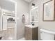 Bathroom featuring a modern vanity, framed mirror, and an open doorway leading to other rooms at 1213 Fairview Dr, Greenfield, IN 46140