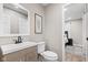 Neutral bathroom featuring a modern vanity, framed mirror, adjacent to an open doorway leading to bedroom at 1213 Fairview Dr, Greenfield, IN 46140