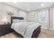 This bedroom features a large bed, wood-look floors, and natural light at 1213 Fairview Dr, Greenfield, IN 46140