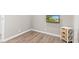 Bedroom with wood-look flooring, natural lighting and mounted TV at 1213 Fairview Dr, Greenfield, IN 46140