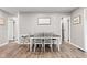 Light and bright dining room features lovely laminate flooring and neutral paint color at 1213 Fairview Dr, Greenfield, IN 46140