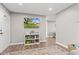 Bright entryway with modern decor, shelving and a view into the dining area at 1213 Fairview Dr, Greenfield, IN 46140