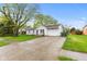 Inviting single-story home with a long driveway, lush green lawn, and attached one-car garage at 1213 Fairview Dr, Greenfield, IN 46140