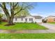 Charming single-story home featuring a well-maintained lawn and mature tree, enhancing curb appeal at 1213 Fairview Dr, Greenfield, IN 46140