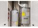 A utility closet features a furnace and water heater with white bi-fold doors at 1213 Fairview Dr, Greenfield, IN 46140