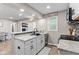 Bright kitchen with white cabinets, gray backsplash, and stainless sink at 1213 Fairview Dr, Greenfield, IN 46140