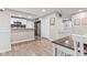 Bright kitchen features white cabinets, stainless appliances, and an open dining area with lovely laminate flooring at 1213 Fairview Dr, Greenfield, IN 46140