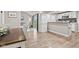 Bright kitchen features white cabinets, stainless appliances, and an open dining area with lovely laminate flooring at 1213 Fairview Dr, Greenfield, IN 46140