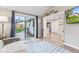 This living room features a gray sofa, sliding glass door, and views into the kitchen and dining area at 1213 Fairview Dr, Greenfield, IN 46140