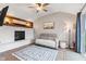 Cozy living room boasts a painted brick fireplace, wood accent wall, and sliding door to the backyard at 1213 Fairview Dr, Greenfield, IN 46140