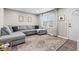 Cozy living room featuring a large sectional couch, neutral decor, and a patterned rug at 1213 Fairview Dr, Greenfield, IN 46140