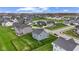 Areal view of a suburban neighborhood with many single Gathering homes and a small pond at 12902 Girvan Way, Fishers, IN 46037