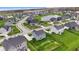 Aerial view of a suburban neighborhood featuring manicured lawns and a small pond at 12902 Girvan Way, Fishers, IN 46037
