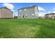 The backyard has a well kept lawn with a fence between the homes at 12902 Girvan Way, Fishers, IN 46037