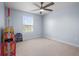 Bedroom with a ceiling fan, one window, neutral carpet, and a toy shelf at 12902 Girvan Way, Fishers, IN 46037