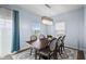 Dining room with a contemporary chandelier, wood table, chair seating, and window views at 12902 Girvan Way, Fishers, IN 46037